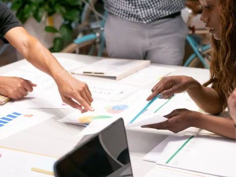 Team reviewing marketing charts and reports at a table